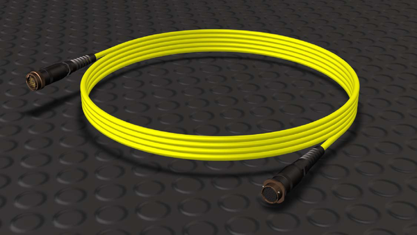 Coiled yellow P26 remote control cable with black circular connectors at both ends, displayed on a dark textured background.