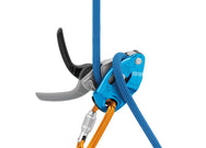 Blue Petzl GRIGRI belay device attached to a carabiner with a blue rope and a hand on the brake side - imagen 2